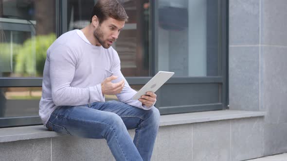 Loss, Man Frustrated by Results on Laptop while Sitting Outside