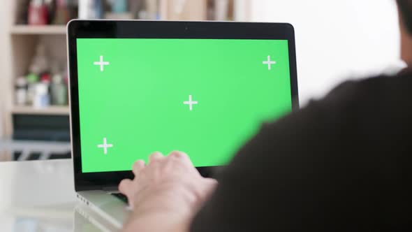 Male Hands Typing a Text on a Laptop with Green Screen on