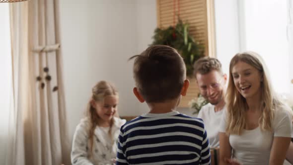 Little boy runs to his family on Christmas morning. Shot with RED helium camera in 8K