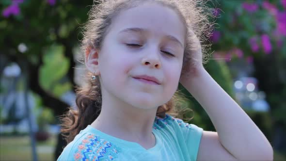 Portrait Cute Little Child Smilling on the Sunset in City Park . Stock Footage.