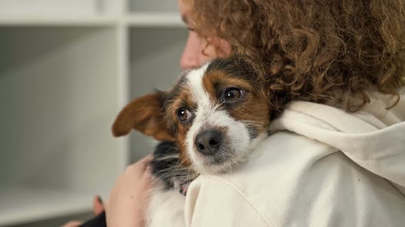 Teenage Girl Holds in Her Arms and Strokes Her Beloved Funny Dog