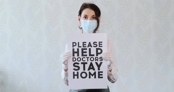 Young Girl in Medical Mask, Being at Home, To Urge Help To Doctors, Showing Poster with the