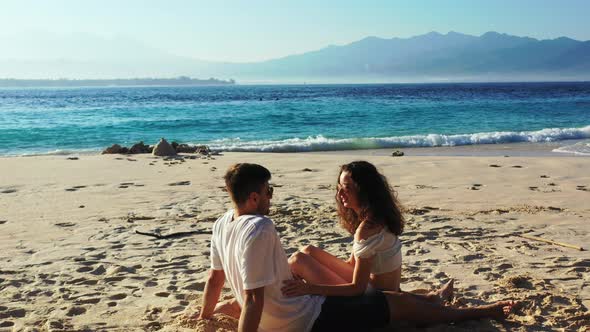 Beautiful lady and man on honeymoon vacation spend quality time on beach on paradise white sand back