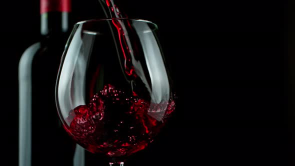 Super Slow Motion Shot of Pouring Red Wine on Black Background at 1000Fps