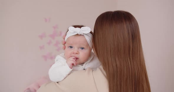 Happy Mother Holds A Newborn Baby In Her Arms And Tenderly Hugs Her