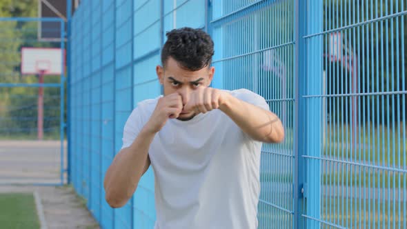 Young Boxer Fighter Wrestler or Football Fan Waving Hands with Clenched Fists Arabic Hispanic Male