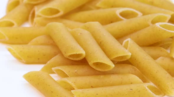 Macro shot of wheat pasta, italian macaroni, macro shot in 4k. Rotating motion, view from above. Clo