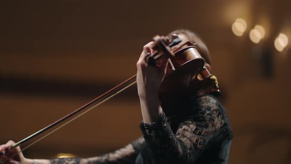 Female Musician is Playing Fiddle in Music Hall Portrait of Woman with Violin Concert in Opera House