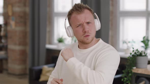 Man in Headphones Dancing to Music before Camera