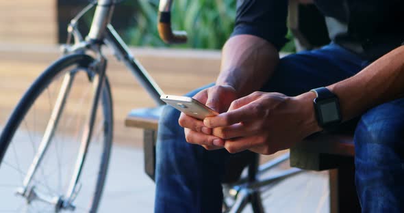 Man checking time on smartwatch while using mobile phone 4k