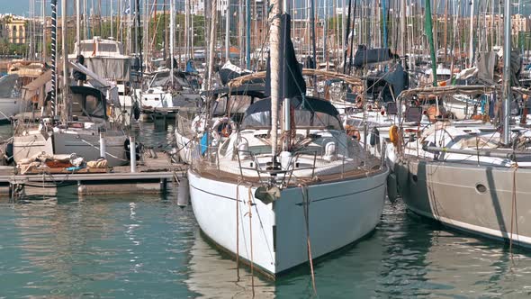 Sea port in Barcelona, Spain. Multiple moored yachts, sunny weather