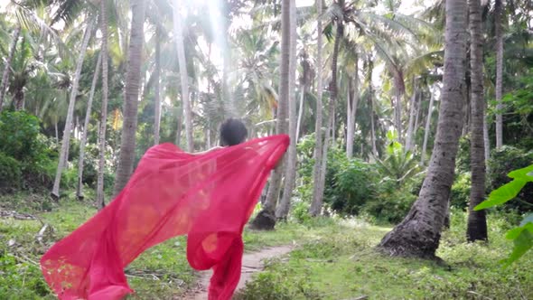 Elegant Sensual Woman in Long Red Romantic Dress Escaping in the Rainforest Majestic Jungle Fairy
