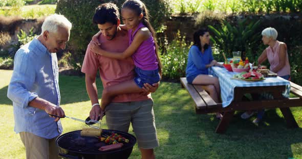 Happy girl, father and grandfather preparing barbecue 4k