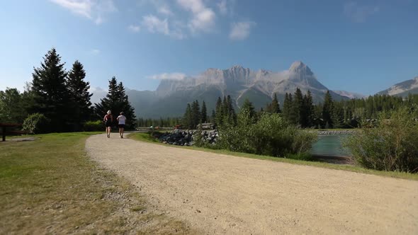 Joggers on Dirt Track with Mountain View