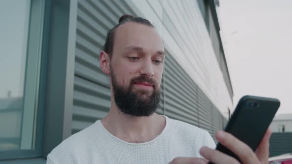 Male Millennial Hipster Holding Modern Smartphone Texting Message