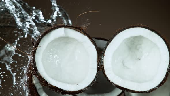 Super Slow Motion Shot of Flying Fresh Coconuts and Water Side Splash at 1000Fps.