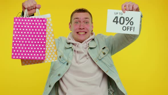 Cheerful Teen Man Showing Shopping Bags and Up To 40 Percent Off Inscriptions Banner Black Friday