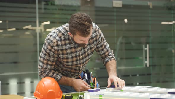 Portrait of Architect Man Working with House Building Project, Planning Playground, Yard 