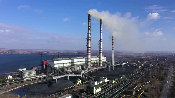 Aerial View of Old Thermoelectric Plant with Big Chimneys in a Rural Landscape Near the Reservoir