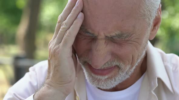 Mature Man Feeling Sudden Sharp Pain in Head