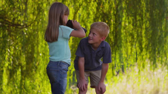 Two kids looking through binoculars