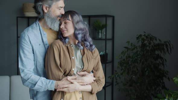 Slow Motion of Happy People Couple Hugging and Kissing Expressing Love Standing at Home Together