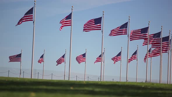 A static shot of three people running by a circle of flags in Washington DC.