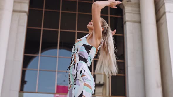 Woman With Blond Ponytail In Fashionable Clothing Posing To Camera