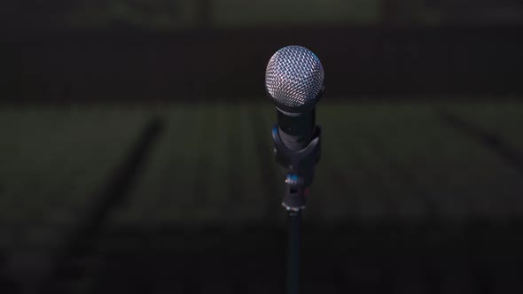 Microphone for Solemn Ceremony or Concert Stands on Stage Dark Background Closeup