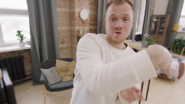 Happy Man Dancing and Posing in Loft Apartment