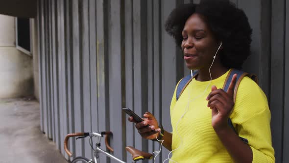 African american woman using smartphone in street