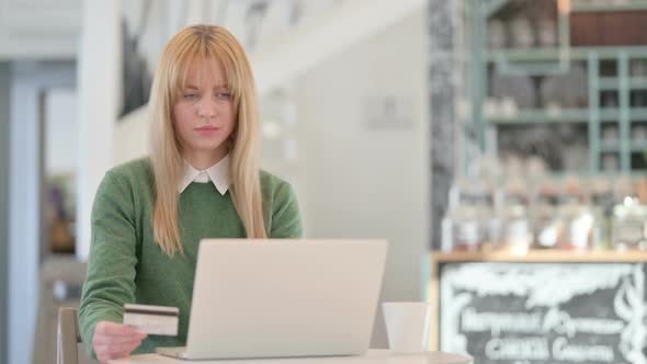 Online Shopping Payment Failure on Laptop By Young Woman in Cafe