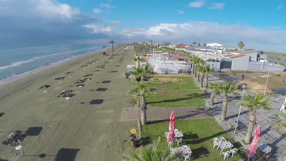 Drone Flying Over Beach Cafe and Palms, View on Larnaca Seashore, Cyprus