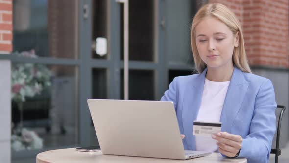 Online Shopping Failure for Young Businesswoman Sitting Outdoor