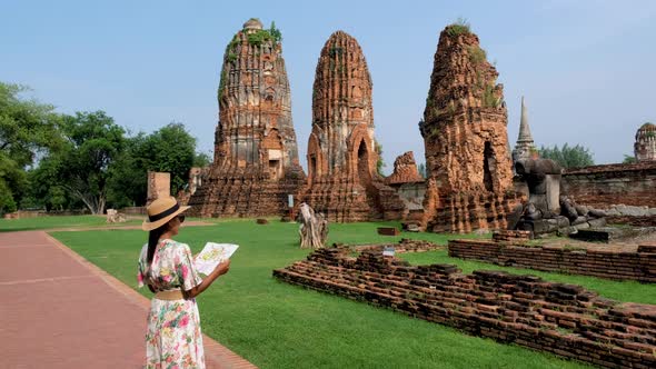 Ayutthaya Thailand at Wat Mahathat Women with a Hat and Tourist Map Visiting Ayyuthaya Thailand