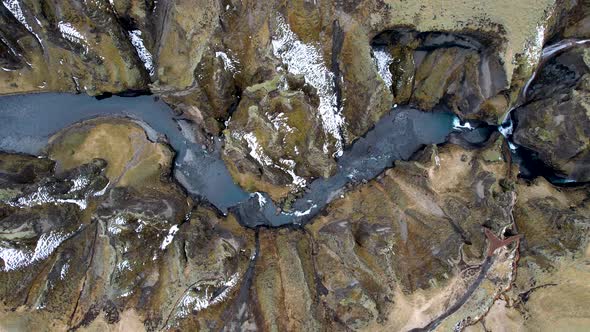 Drone flying high over winding canyon and river in Iceland