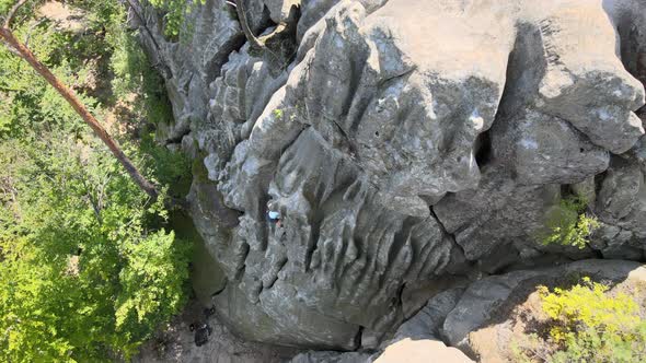 Strong Child Climber Climbing Steep Wall of Rocky Mountain