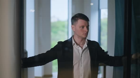 Young Confident Man Opening Curtains in Office Walking Away in Slow Motion