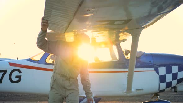 Male Pilot Checks Airplane Wings