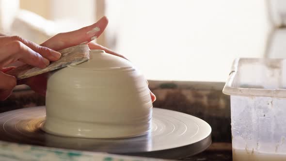 Mid section of potter making pot