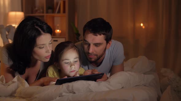 Happy Family with Tablet Pc in Bed at Home 12