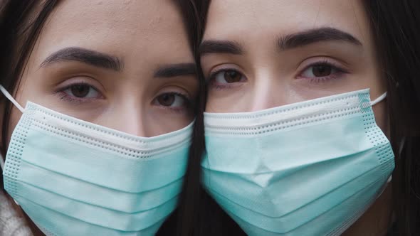 Portrait two caucasian twin girls in medical protective face mask. Outbreak of coronavirus COVID-19.