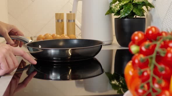 Woman Turn on Induction Hob with Frying Pan