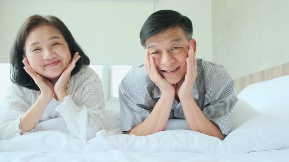 happiness wellness healthy old senior asian couple smile laugh together enjoy laydown