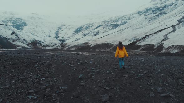 Woman walking in big snowy valley