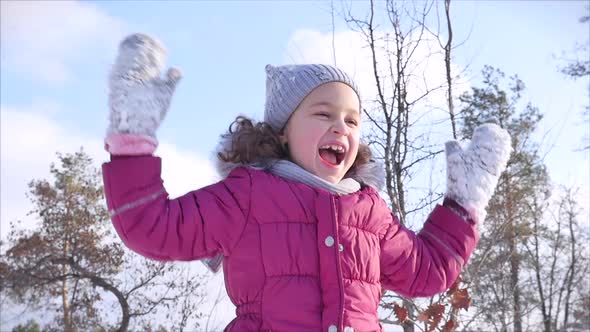 Happy, Fun Childhood on a Sunny Winter Day Outdoors. Happy Little Girl While Having Fun and Smiling