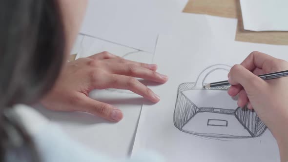 Close Up Of Asian Woman Designer Positively Shaking Her Head While Looking At The Layout Bond