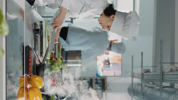 Vertical Video Team of Cooks Preparing Fresh Ingredients to Follow Culinary Recipe