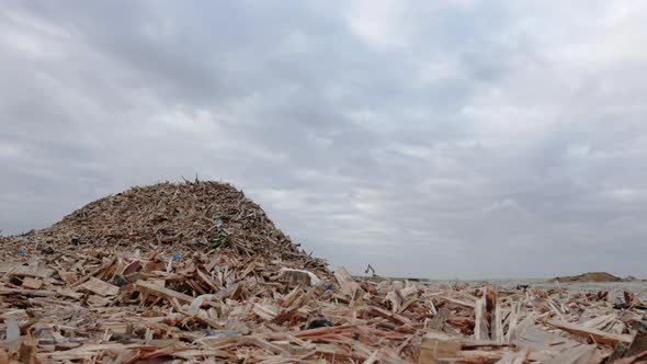View of a garbage dump with piled scraps of wood