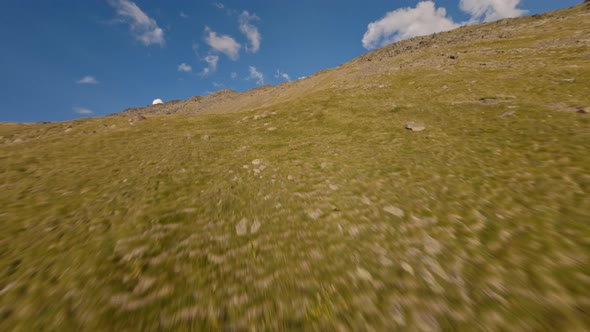 FPV Drone Shot Flying Over Sunny Natural Rocky Valley with Waterfall Rural Path Stones Geology